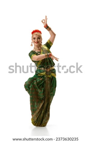 Odissi dance. Beautiful woman in indian costume, with makeup and accessories dancing against white studio background. Concept of beauty, fashion, India, traditions, lifestyle, choreography, art. Ad