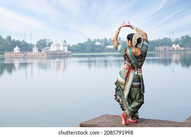 Odissi is a major ancient Indian classical dance form.Indian girl dancer in the posture at Bindu Sagar, bhubaneswar, Odisha, India. Culture and traditions of India.