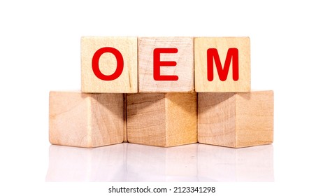 OEM abbreviation of original equipment manufacturer text on wooden cubes on a white background.
