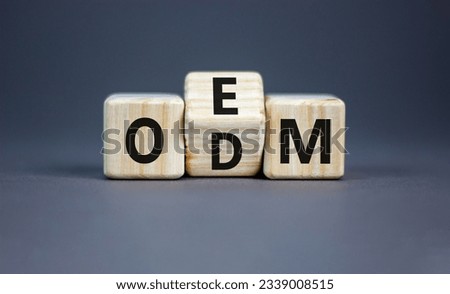 OEM or ODM symbol. Concept word OEM ODM original design equipment manufactirer on wooden block. Beautiful grey table grey background, copy space. Business and OEM ODM concept.