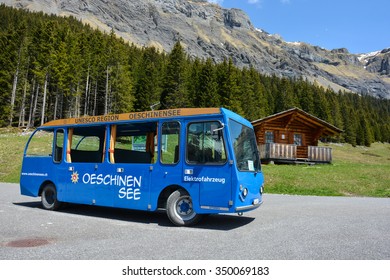 Oeschinensee, Switzerland - 10th May, 2015. Unesco World Heritage Site. Small Electric Bus Is Waiting For Guests At The Upper Station Of The Aerial Cable Car. 
Photo Taken On: 10th May, 2015.