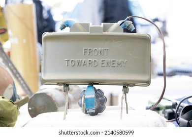 O'FALLON, MISSOURI - March 27, 2022: A Training M18 Claymore Mine Used By The US Military On Display With A Fragmentation Grenade Underneath. Both Weapons Used During The Vietnam War.