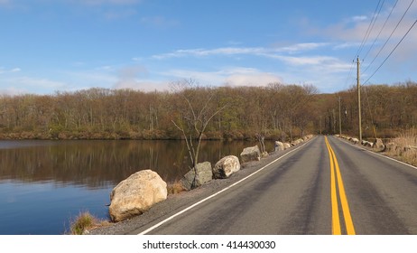 Off centered view of road next to lake