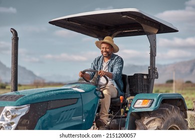 Off to the fields we go. Shot of a mature man driving a tractor on a farm. - Powered by Shutterstock