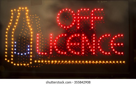 Off Licence Liquor Store Alcohol For Sale Neon Light Sign At Night Photo.