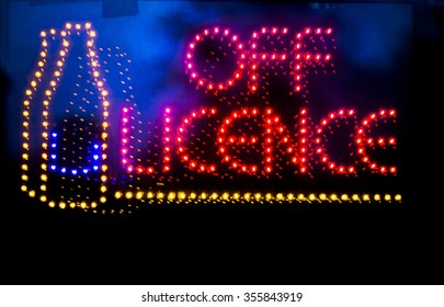 Off Licence Liquor Store Alcohol For Sale Neon Light Sign At Night Photo.