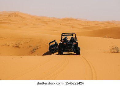 Off Road Buggys Crossing Dunes In The Desert. Rally Raid Adventure.