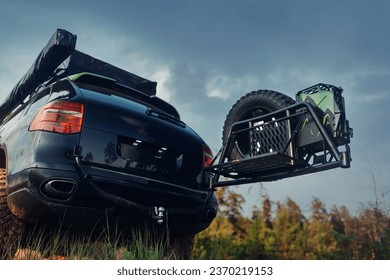 Off road car is stopped at the field with open trunk - Powered by Shutterstock