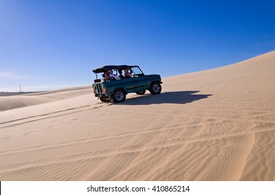 Off Road Car Vehicle In White Sand Dune Desert At Mui Ne, Vietnam