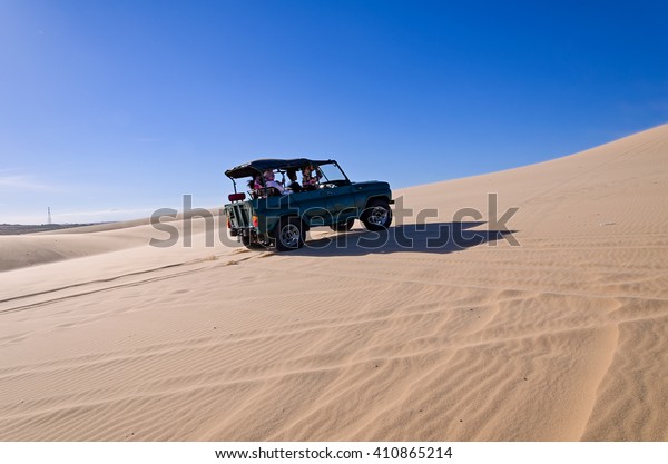 off road car vehicle in white sand dune desert at\
Mui Ne, Vietnam