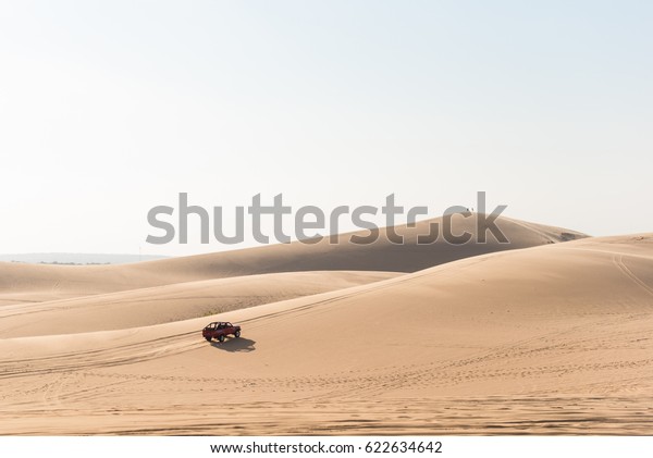 off road car vehicle in white sand dune desert at\
mui ne, vietnam