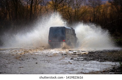 Off road. Suv splash on the river outdoor, traveling on the road. cene of mud splash in off-road racing. Stop action with high speed shutter