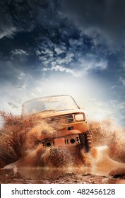 Off road vehicle coming out of a mud hole hazard,mud and water splash in off-road racing. - Shutterstock ID 482456128