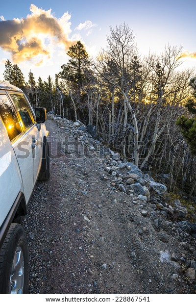 Off road\
vehicle on a rocky road in colorado\
rockies