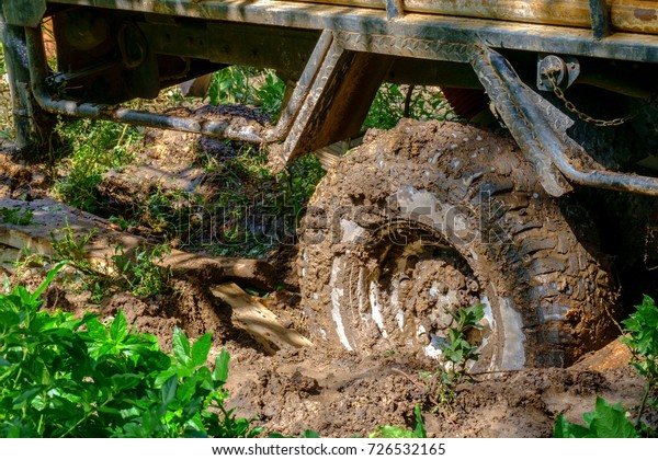 Off road wheel stuck in mud. Mud wheel terrain\
in the forrest.