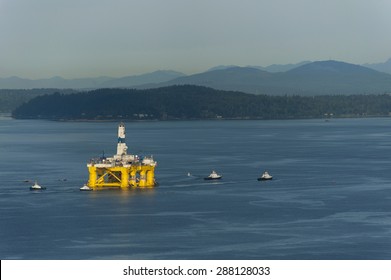 Off Shore Oil Rig. Tug Boats Escort An Off Shore Oil Drilling Rigs As It Leaves Seattle, Washington To Return To Alaska.