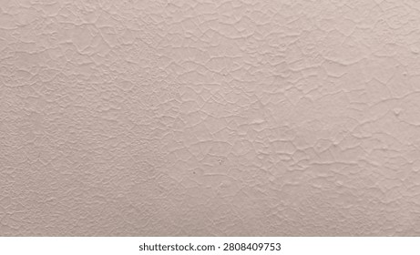 Off white textured surface shows cracked paint pattern. Light tone reveals subtle detail and rough grain. Close view displays organic lines across flat area. Background provides neutral space.