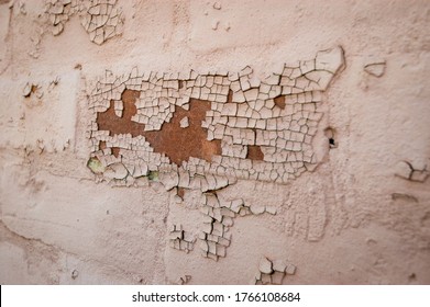 Off WhitePaint Chipping of a Tan Wall
