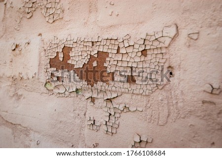 Off WhitePaint Chipping of a Tan Wall