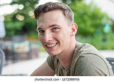 An off-duty United States Marine looking at the camera and smiling - Powered by Shutterstock