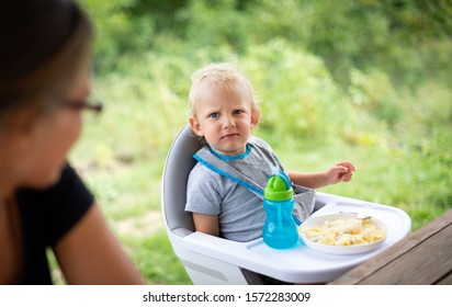 Offended And Fussy Little Child Boy During Eating Outdoor