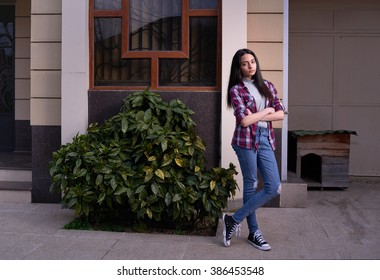 offended girl stands outside her house. - Shutterstock ID 386453548