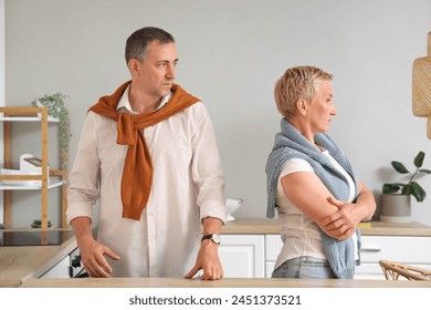 Offended mature couple after quarrel in kitchen - Powered by Shutterstock