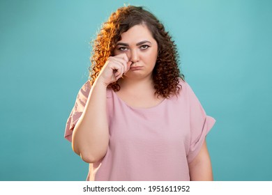 Offended Plus Size Woman. Body Shaming. Abuse Bulling. Overweight Struggle. Sad Fatty Lady Looking Disappointed Wiping Tears Hand Isolated Blue.