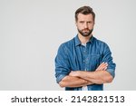 Offended sad angry caucasian young man with arms crossed blowing his lips looking at camera isolated in white background. Conflict anger concept