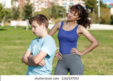 Offended Tween Boy Standing On Sports Ground  While Mom Scolding Him