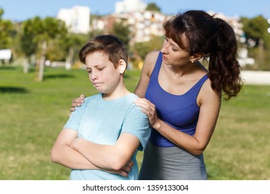 Offended Tween Boy Standing On Sports Ground  While Mom Scolding Him