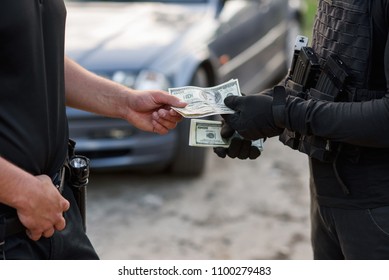 The Offender Gives Money To The Police Officer. Stop Corruption And Bribes. A Corrupt Policeman Taking US Dollars From Terrorist.