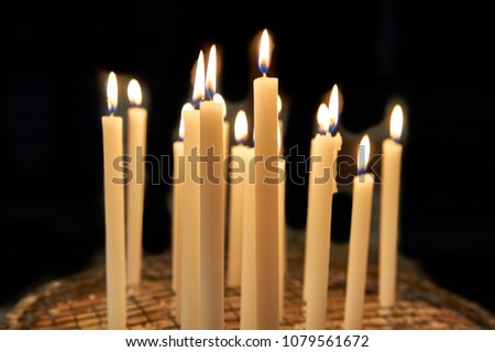 offering of candles inside a church