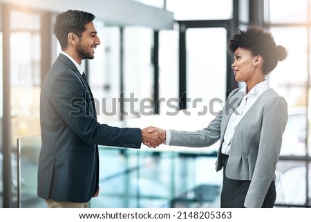 Offering a handshake with sincerity, confidence and authority. Shot of two businesspeople shaking hands.