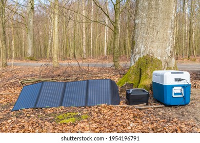 Off-grid camping equipment, which consists of a collapsible solar panel, power generator and a compressor cooler

 - Shutterstock ID 1954196791