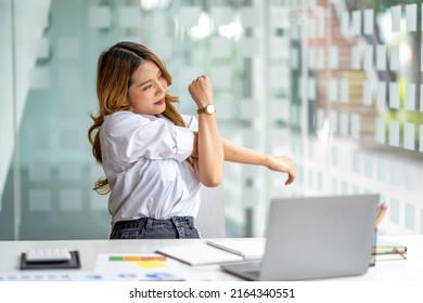 Office asian business woman stretching body for relaxing while working with laptop computer at her desk, office lifestyle, business situation - Shutterstock ID 2164340551