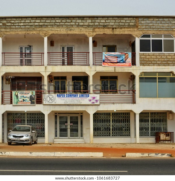 Office building in Accra. Balconies with advertising\
billboards. Development of business in Ghana. Construction industry\
in West Africa. Urban landscape. City life. Ghana, Accra - January\
15, 2017 