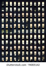 Office Building Exterior In The Late Evening With Interior Lights On