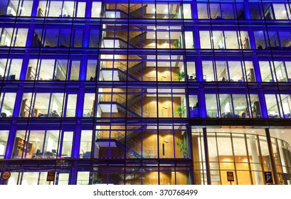 Office Building Exterior With People At Work At Night