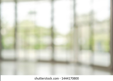 Office Building Lobby Hall Blur Background Or Blurry School Hallway Corridor Interior View Looking Toward Empty Corridor Entrance, Glass Curtain Wall And Floor With Exterior Light Illumination