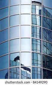 Office Building Reflections - Sails in Windows. Pattern of windows on a clear blue day.