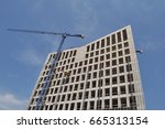 office building under construction with crane