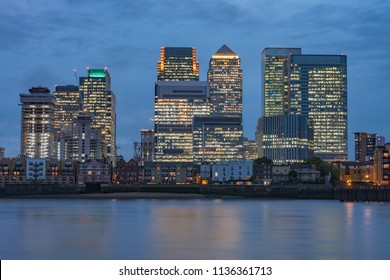 Office buildings in Canary Wharf, commercial, financial centre on the Isle of Dogs in London in the evening. 