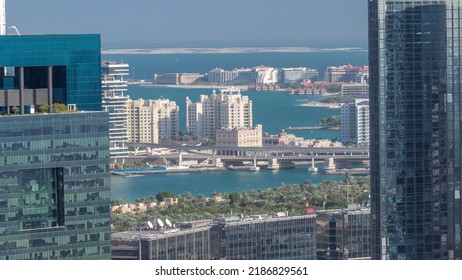 Office Buildings In Dubai Internet City And Media City District Aerial Timelapse. Houses On Palm Island And Skyscrapers