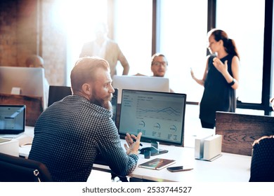 Office business scene with diverse team working. Professionals collaborate at computers. Bright business office, teamwork, and technology. Busy office environment with business colleagues. - Powered by Shutterstock