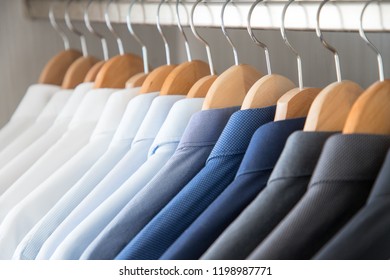 Office Business Shirts Hanging In A Closet Ordered By Colour