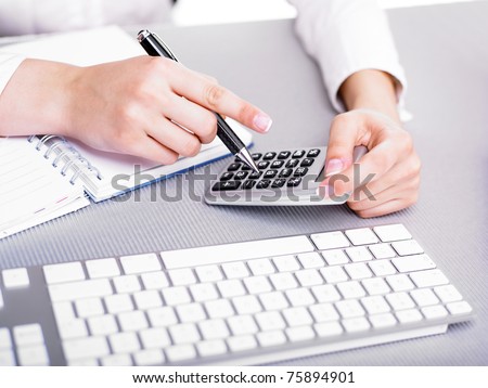 Office business woman calculating with calculator and pencil