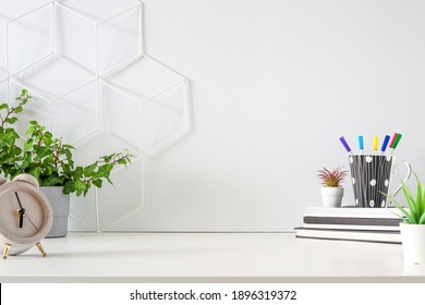 An office by an empty wall. Home Office. School desk. Copy space. Plants at home.