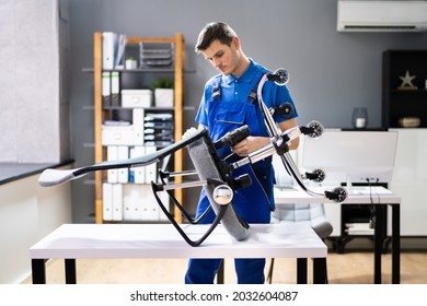 Office Chair Assembling And Repair. Man Working With Tool