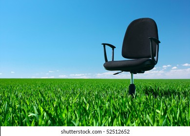 Office Chair Standing On Green Meadow